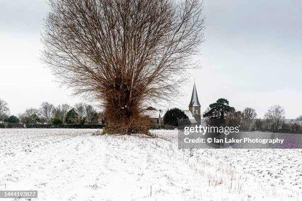 ickham, kent, england, uk. 8 february 2021. distant view of ickham church in the snow. - south east england stock pictures, royalty-free photos & images