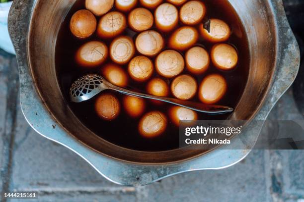 chinese eggs boiled with tea and salt, popular for breakfast - crack spoon stock pictures, royalty-free photos & images