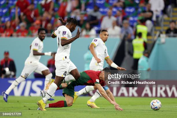 Cristiano Ronaldo of Portugal is brought down by Mohammed Salisu of Ghana during the FIFA World Cup Qatar 2022 Group H match between Portugal and...