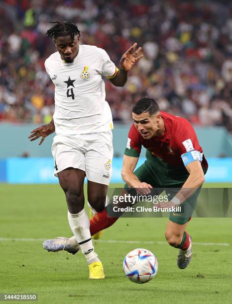 Cristiano Ronaldo of Portugal is brought down by Mohammed Salisu of Ghana during the FIFA World Cup Qatar 2022 Group H match between Portugal and...