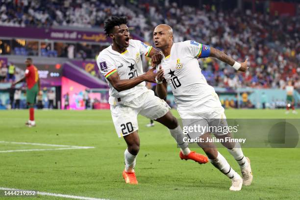 Andre Ayew of Ghana celebrates with Mohammed Kudus after scoring their team's first goal during the FIFA World Cup Qatar 2022 Group H match between...