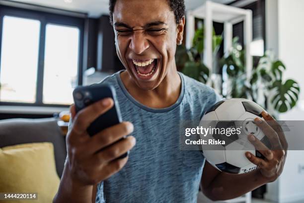 winning an online bet on a football game - man gambling stock pictures, royalty-free photos & images