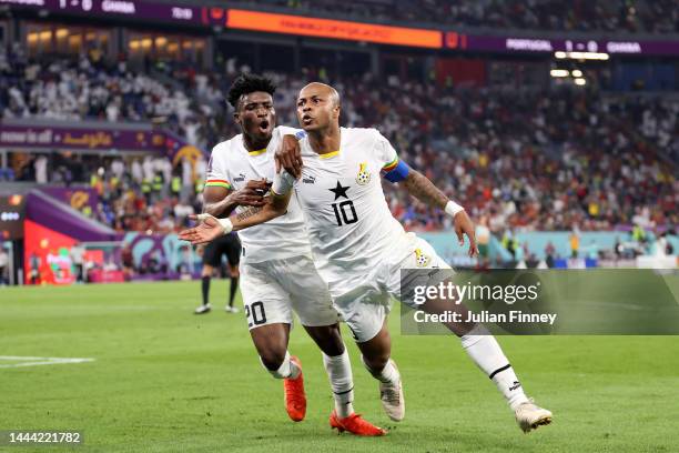 Andre Ayew of Ghana celebrates with Mohammed Kudus after scoring their team's first goal during the FIFA World Cup Qatar 2022 Group H match between...