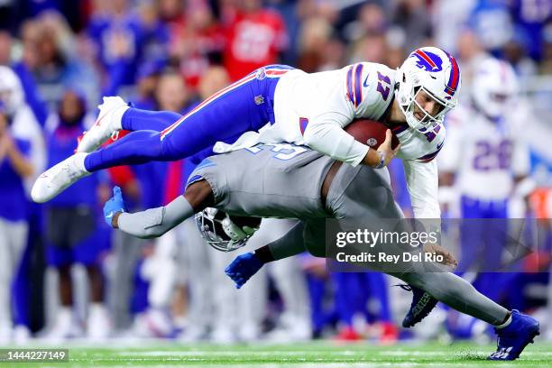 Kerby Joseph of the Detroit Lions tackles Josh Allen of the Buffalo Bills during the first quarter at Ford Field on November 24, 2022 in Detroit,...