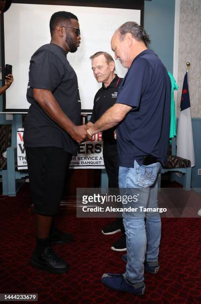 Sean "Diddy" Combs, Rev. Ronald Brummitt and Ron Book celebrated Thanksgiving Day at The Caring Place in Miami on November 24, 2022 in Miami, Florida.