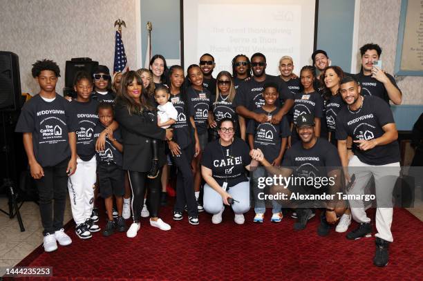 Volunteers posed with Yung Miami, Sean "Diddy" Combs and his family, his daughters Chance, D'Lila and Jessie, as they celebrated Thanksgiving Day at...