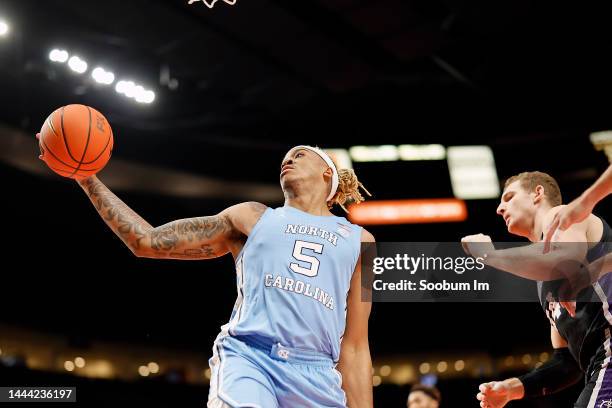 Armando Bacot of the North Carolina Tar Heels grabs a rebound next to Joey St. Pierre of the Portland Pilots during the first half at Moda Center on...