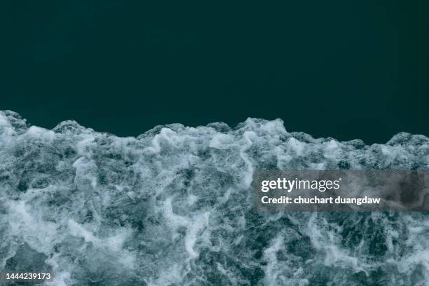 ripples on sea surface blue aerial view - high tide stock-fotos und bilder