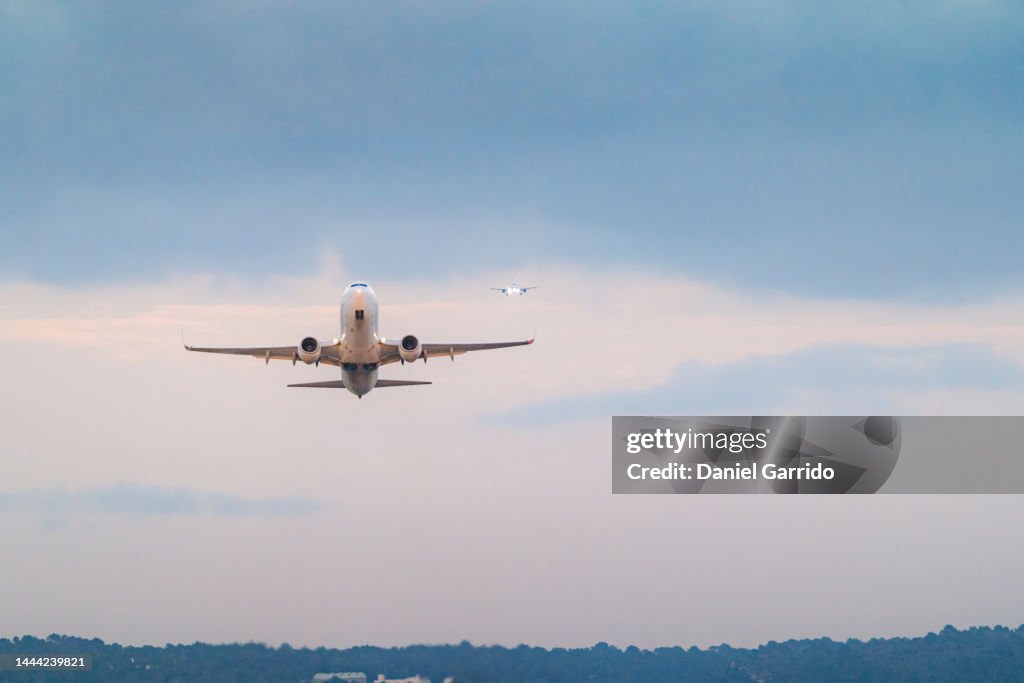 Airplane in front taking off and another behind landing, travel and tourism, aircraft themes