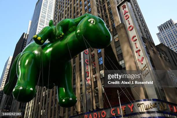 Dino balloon walks past Radio City during the 96th-annual Macys Thanksgiving Day Parade on November 24, 2022 in New York City. The annual Macy’s...