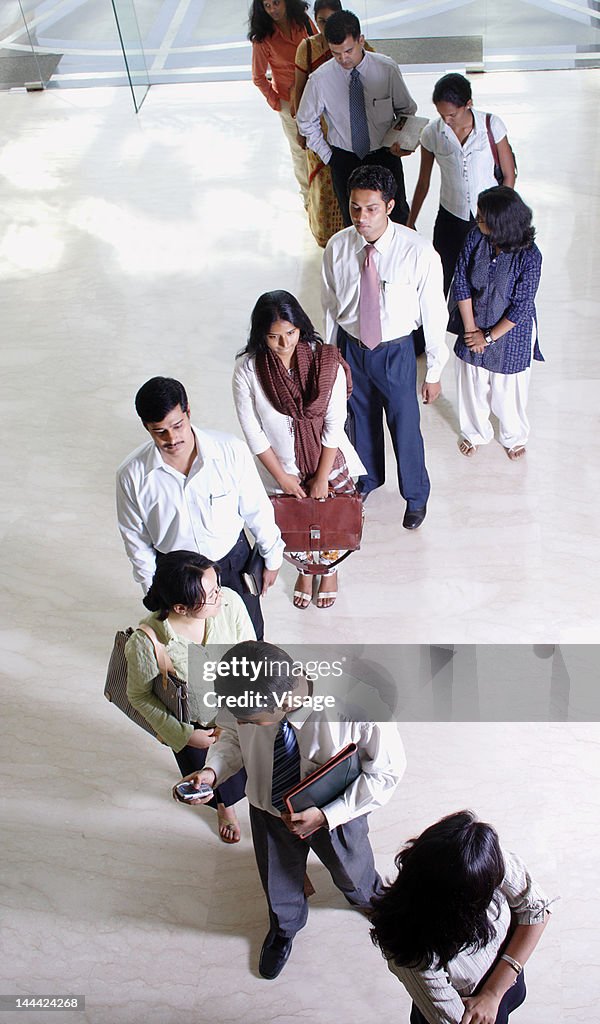 Business people standing in a queue