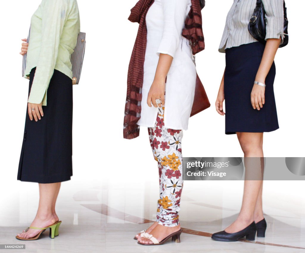 Three women standing in a queue, Low section