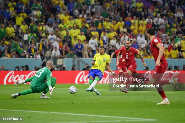 Raphinha of Brazil shoots the ball against Vanja Milinkovic-Savic of Serbia during the FIFA World Cup Qatar 2022 Group G match between Brazil and...