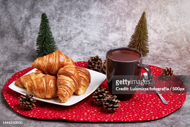 cup of hot chocolate with a plate with croissant on a red christmas tablecloth,spain - christmas breakfast stock pictures, royalty-free photos & images