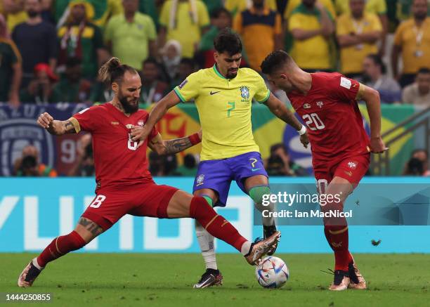 Lucas Paquetá of Brazil vies with Sergej Milinković-Savić of Serbia and Nemanja Gudelj of Serbia during the FIFA World Cup Qatar 2022 Group G match...