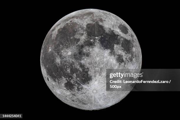 low angle view of moon against clear sky at night,guadix,granada,spain - manen stockfoto's en -beelden