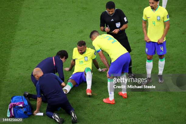 Neymar of Brazil is attended to by medical staff during the FIFA World Cup Qatar 2022 Group G match between Brazil and Serbia at Lusail Stadium on...
