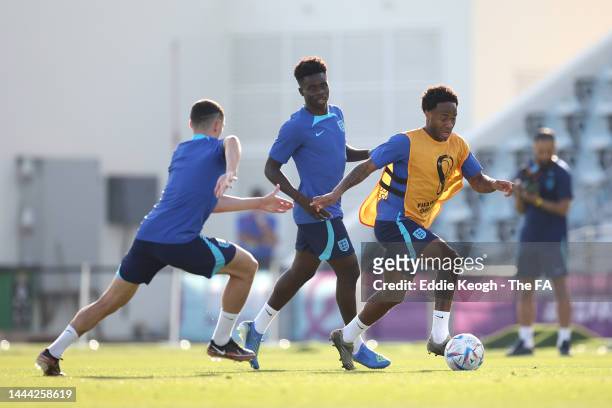 Raheem Sterling of England runs with the ball during a training session at Al Wakrah Stadium on November 24, 2022 in Doha, Qatar.
