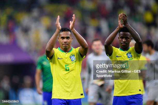 Alex Sandro and Vinicius Junior celebrates victory and applauds fans after the FIFA World Cup Qatar 2022 Group G match between Brazil and Serbia at...