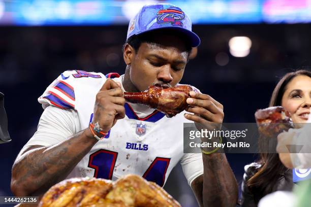 Stefon Diggs of the Buffalo Bills celebrates on the field by eating a turkey leg after defeating the Detroit Lions at Ford Field on November 24, 2022...