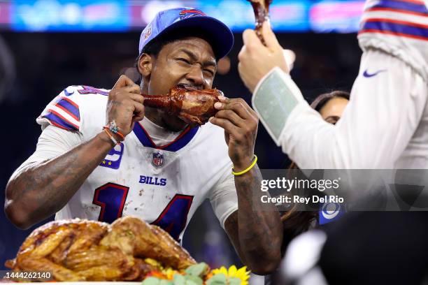 Stefon Diggs of the Buffalo Bills celebrates on the field by eating a turkey leg after defeating the Detroit Lions at Ford Field on November 24, 2022...