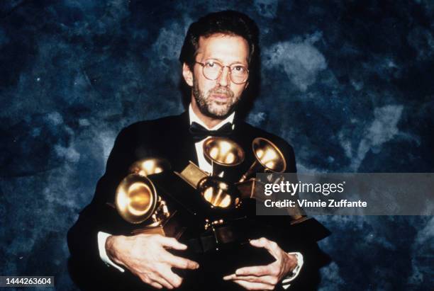 Eric Clapton poses with the six Grammys he won at the 35th annual Grammy Awards. His song "Tears in Heaven" won both as record and song of the year,...