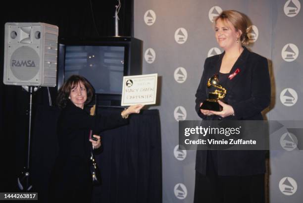 Mary Chapin Carpenter holds up trophy after winning award at the 36th Annual Grammy Awards, held at Radio City Music Hall in New York City, New York,...