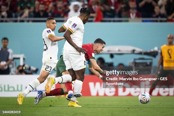 Alexander Djiku of Ghana fouls Cristiano Ronaldo of Portugal followed by a penalty during the FIFA World Cup Qatar 2022 Group H match between...