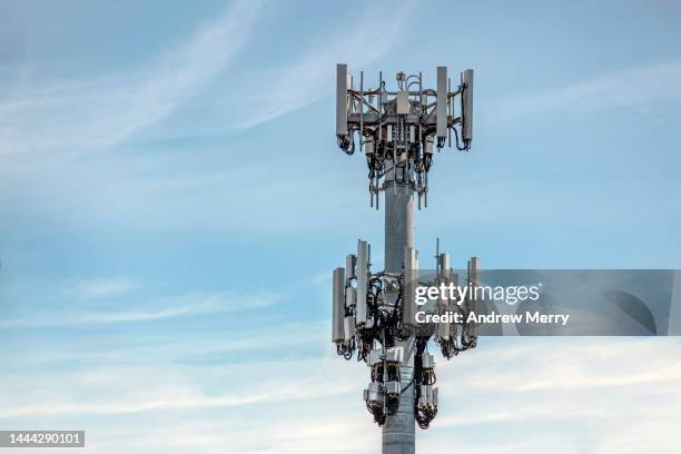 communications cell tower mobile phone data blue sky clouds - repeater tower stock-fotos und bilder
