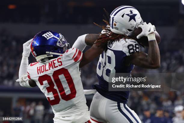 CeeDee Lamb of the Dallas Cowboys catches a pass while defended by Darnay Holmes of the New York Giants during the second half at AT&T Stadium on...