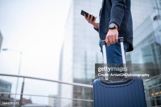 businessman on a work trip using smart phone. - business class stock pictures, royalty-free photos & images