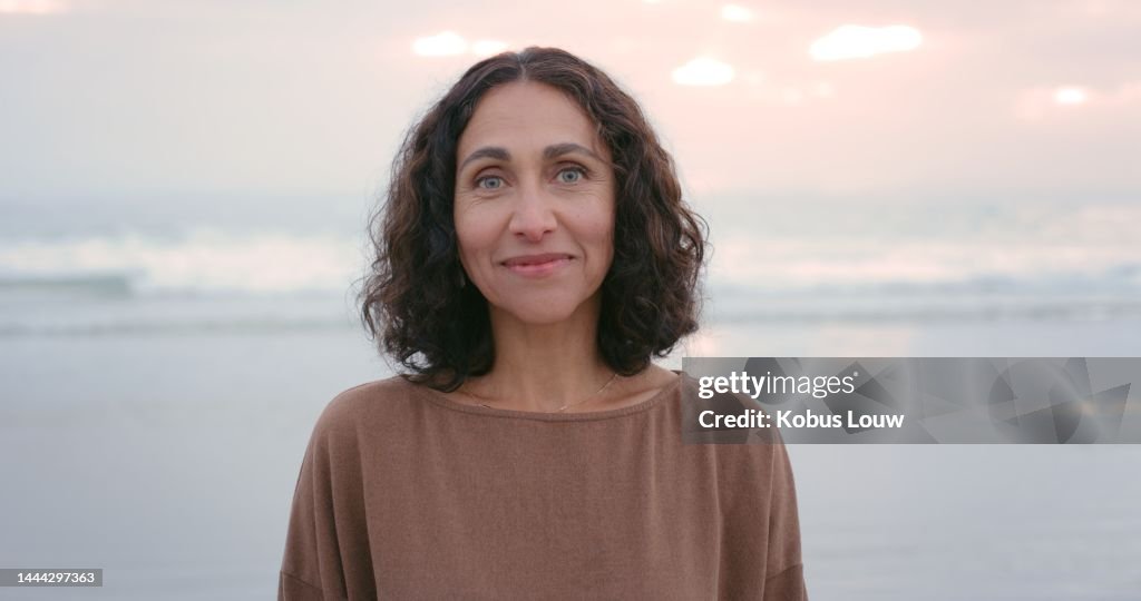 Relax, woman and beach portrait at sunset with smile for freedom, wellness and holiday. Summer, happy and peace of person enjoying calm evening at ocean on Brazil vacation with real face.