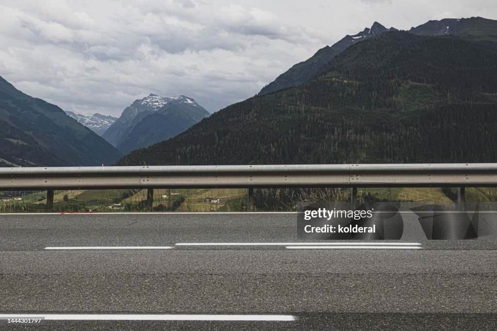 Highway asphalt road with distant view of European Alps, Tyrol, Austria