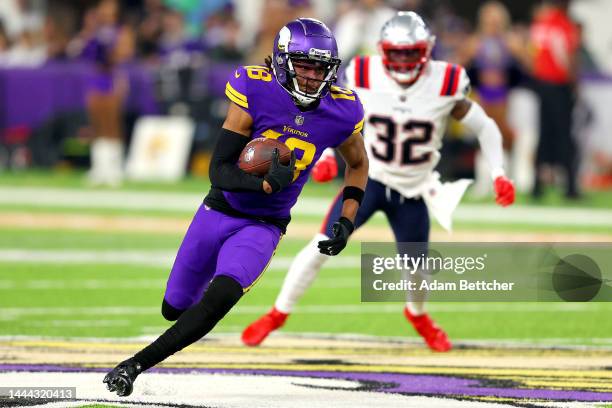 Justin Jefferson of the Minnesota Vikings carries the ball against the New England Patriots during the first half at U.S. Bank Stadium on November...