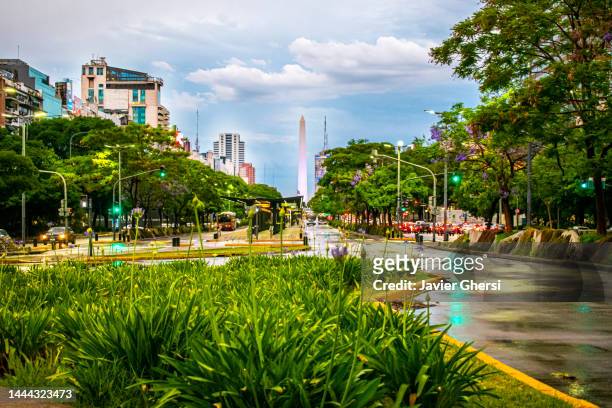 the obelisk and 9 de julio avenue on a rainy day. buenos aires, argentina. - buenos aires obelisk stock pictures, royalty-free photos & images