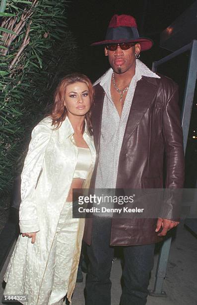 New Laker Dennis Rodman celebrates his first winning game out on the town at GOODBAR with wife Carmen Electra in Beverly Hills, CA, February 26, 1999.