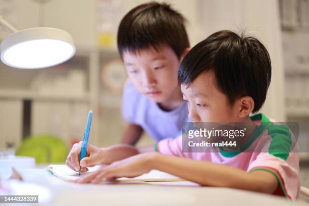 little boy painting and writing - chinese kid stockfoto's en -beelden