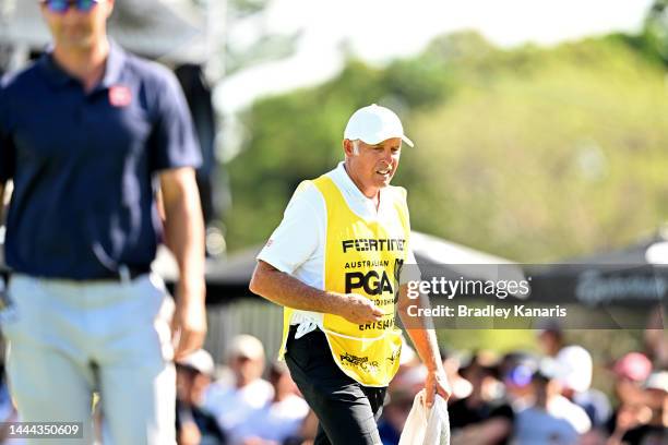 Adam Scott of Australia lines up a putt while his caddie Steve Williams can be seen during Day 2 of the 2022 Australian PGA Championship at the Royal...