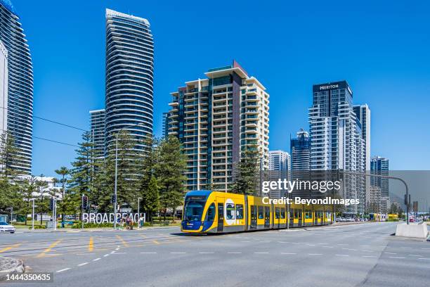 gold coast light rail passing broadbeach sign, gold coast, queensland - queensland rail stock pictures, royalty-free photos & images