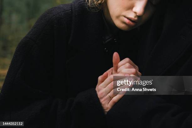 an elderly man and a young woman mourn in the cemetery for the deceased. father and daughter. hands close up - trauerzeit stock-fotos und bilder