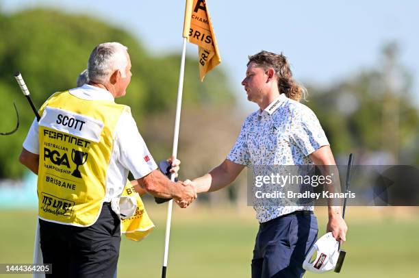 Cameron Smith of Australia shakes hands with Adam Scott's caddie Steve Williams after the 18th hole during Day 2 of the 2022 Australian PGA...