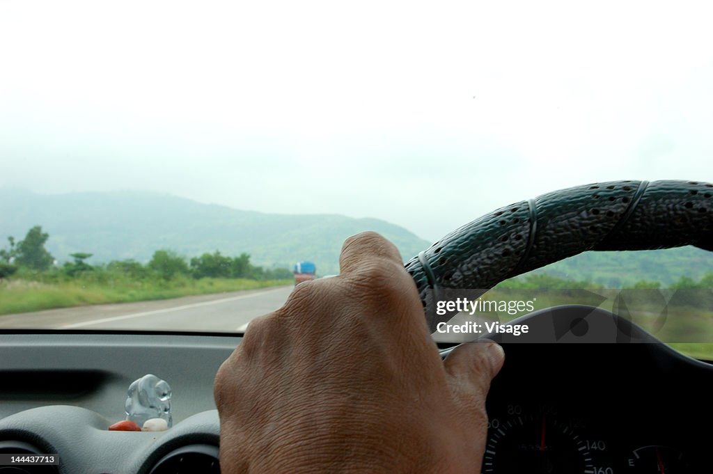 Partial view of steering and dashboard of a car