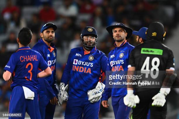 Rishabh Pant and Suryakumar Yadav of India wait for a review for a lbw on Tom Latham of the Black Caps during game one of the One Day International...