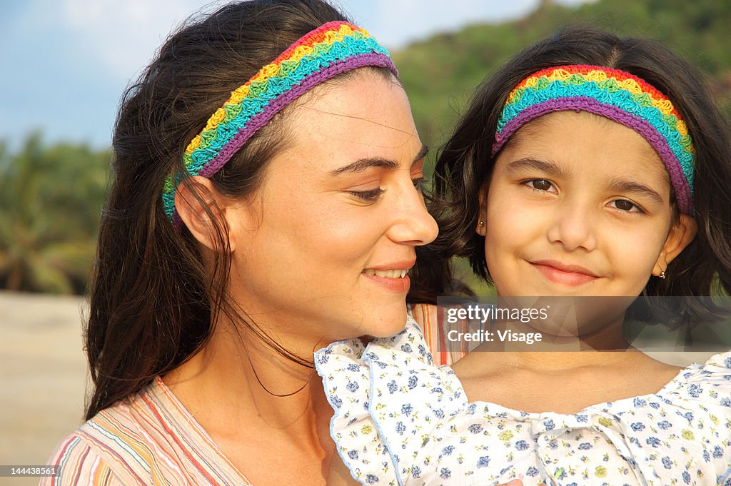 Small girl sitting with her mother