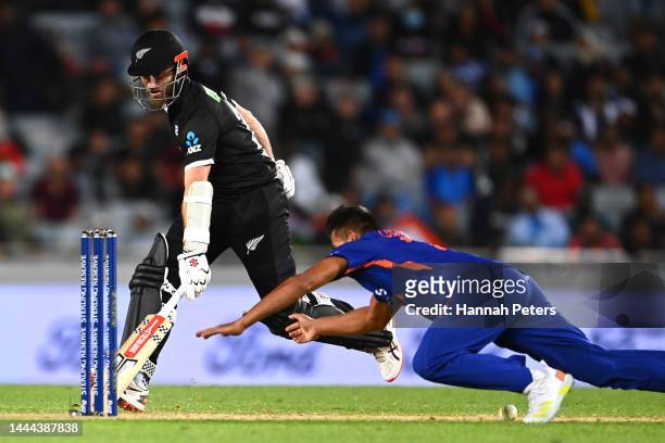 Kane Williamson of the Black Caps runs back into his crease as Umran Malik of India fields during game one of the One Day International series...