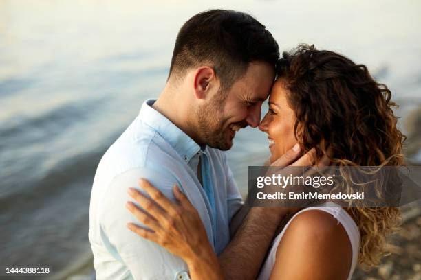 couple in love by the river - falling in love stock pictures, royalty-free photos & images