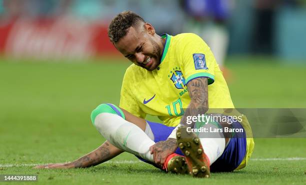 Neymar of Brazil sits injured on the pitch during the FIFA World Cup Qatar 2022 Group G match between Brazil and Serbia at Lusail Stadium on November...