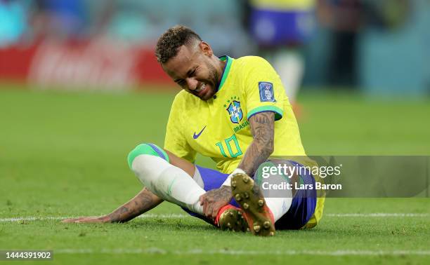 Neymar of Brazil sits injured on the pitch during the FIFA World Cup Qatar 2022 Group G match between Brazil and Serbia at Lusail Stadium on November...