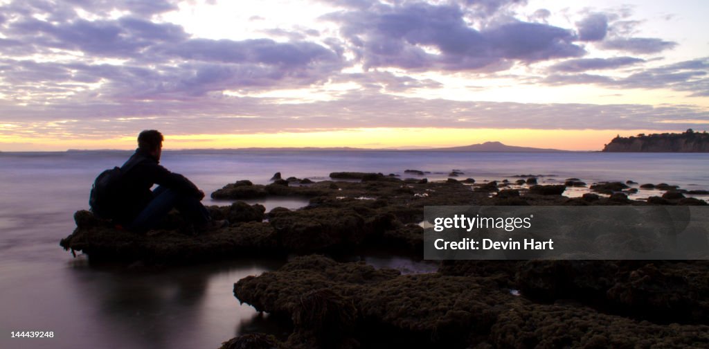 Sitting on a beach staring at a sunrise