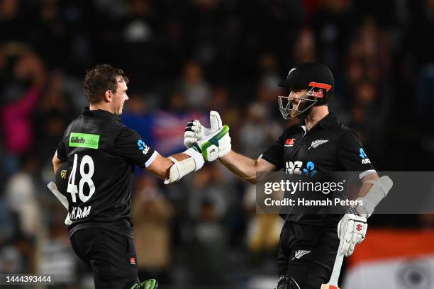 Tom Latham of the Black Caps celebrates after scoring a century with Kane Williamson of the Black Caps during game one of the One Day International...